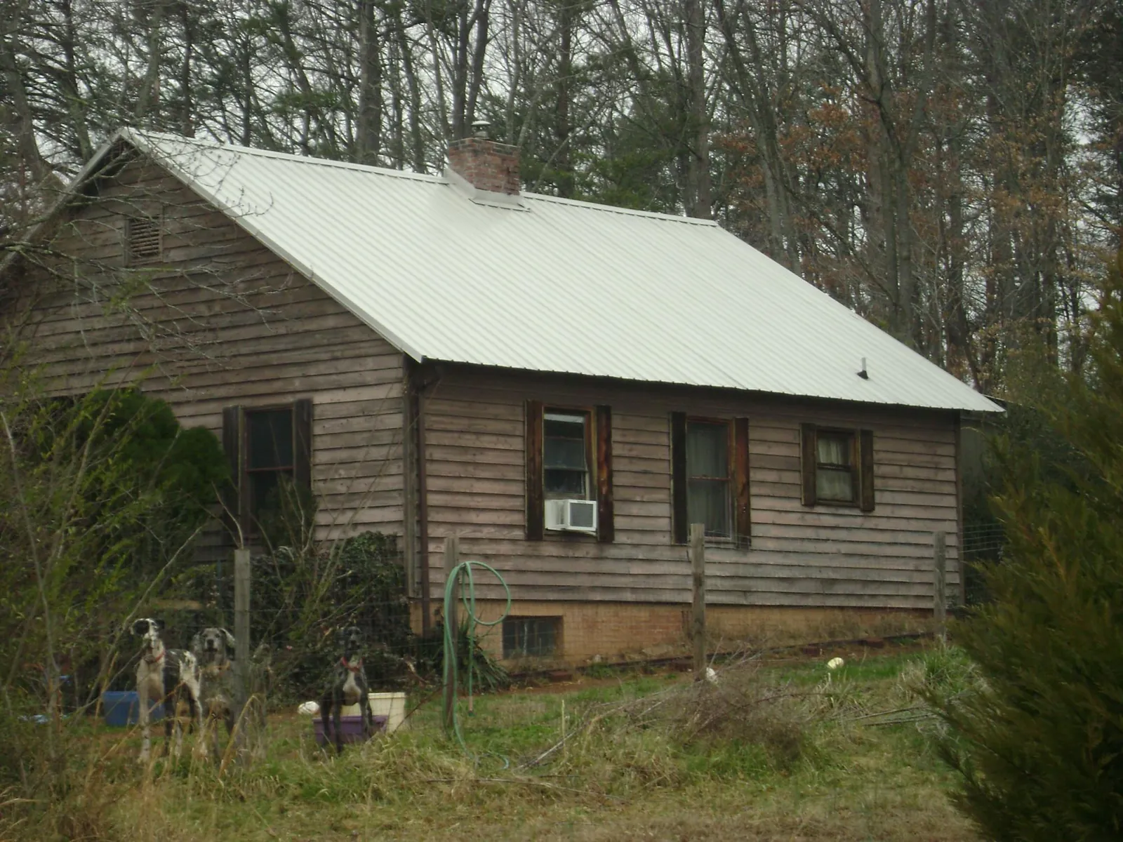 White metal roof on an old wood sided farmhouse, from a Metal Roof Installation job in Walford